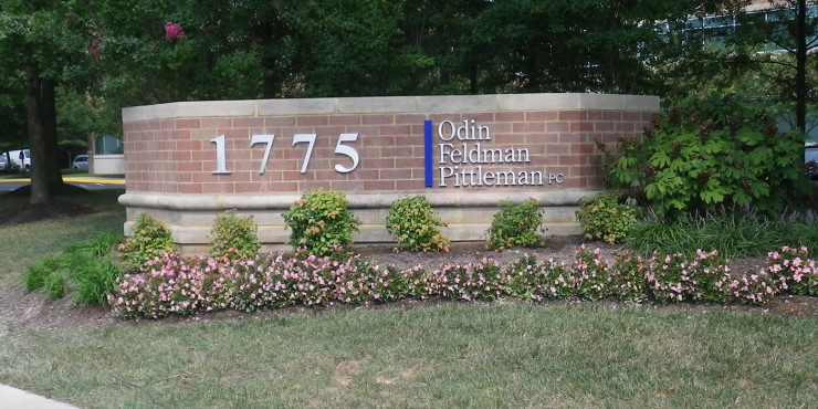 Outdoor sign on brick monument